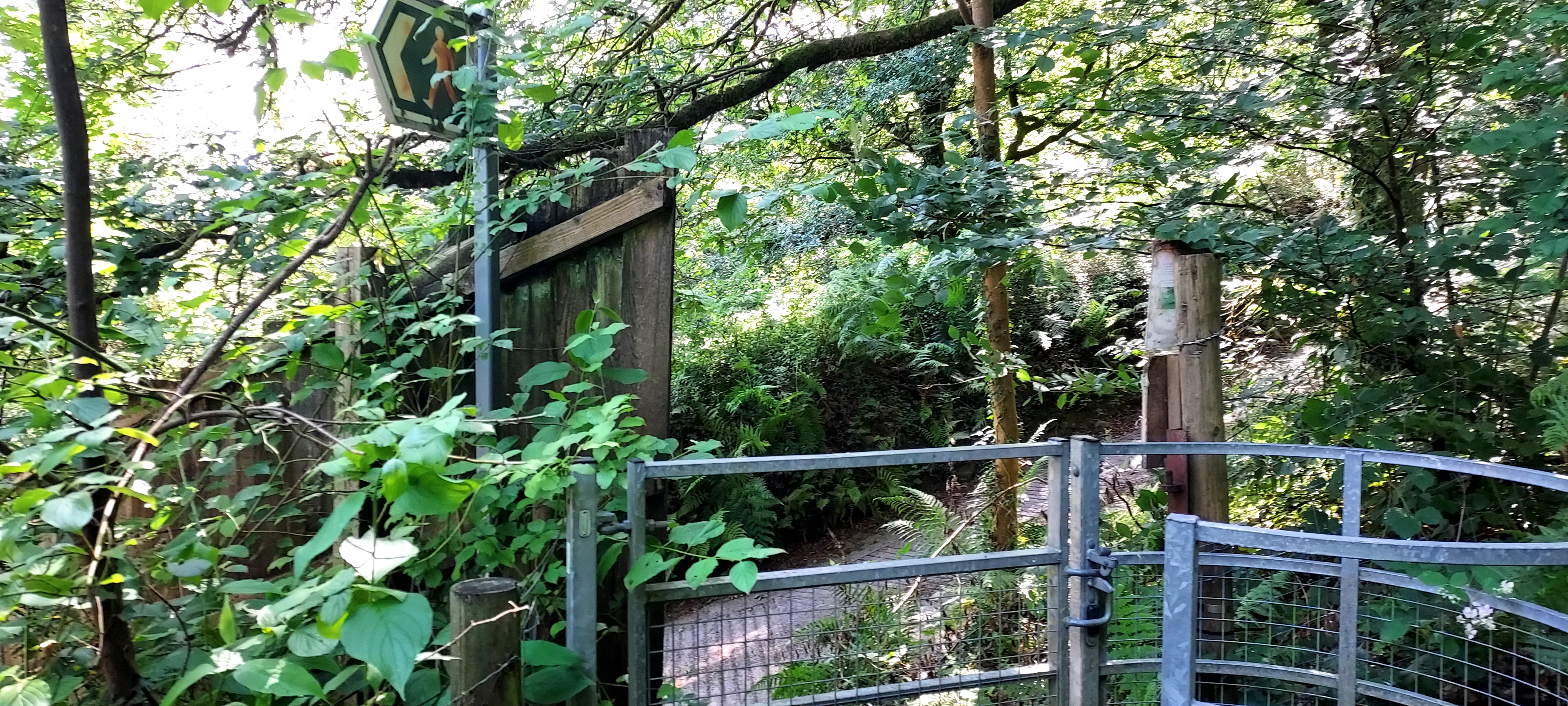 Gate and footpath sign at the end of a woodland walk