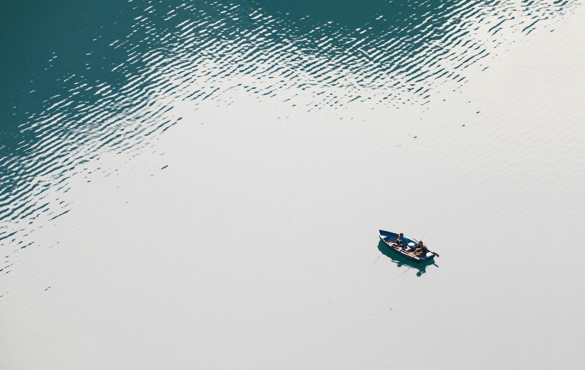Small boat floating in open water