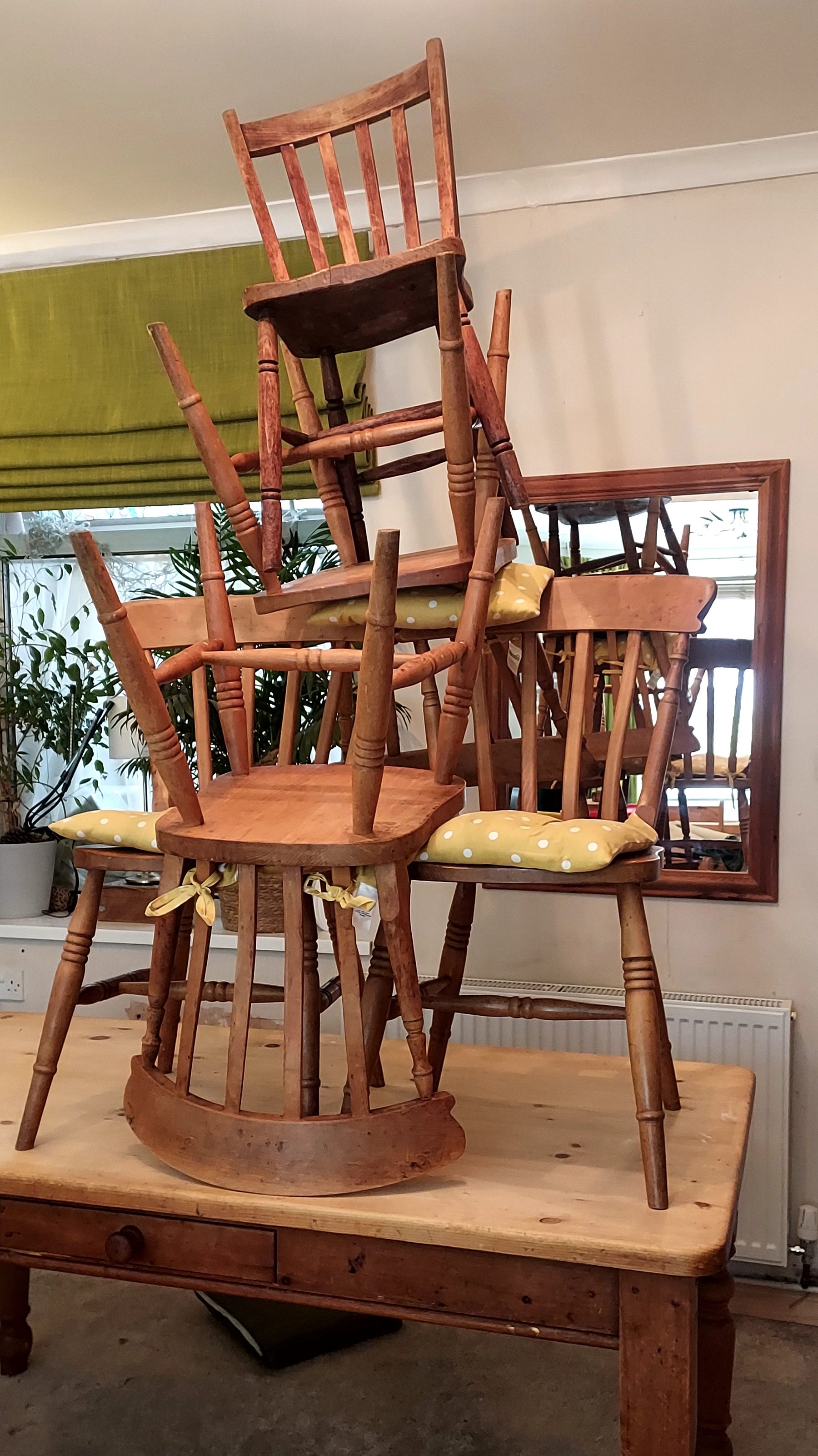 Wooden chairs stacked in chaotic fashion on top of dining table Wooden chairs stacked in chaotic fashion on top of dining table
