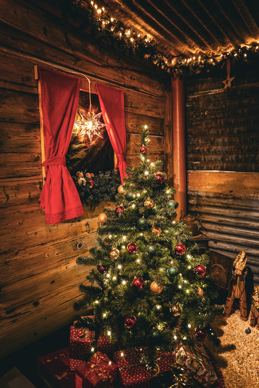 Christmas tree, lights and presents in the corner of a cosy wooden cabin