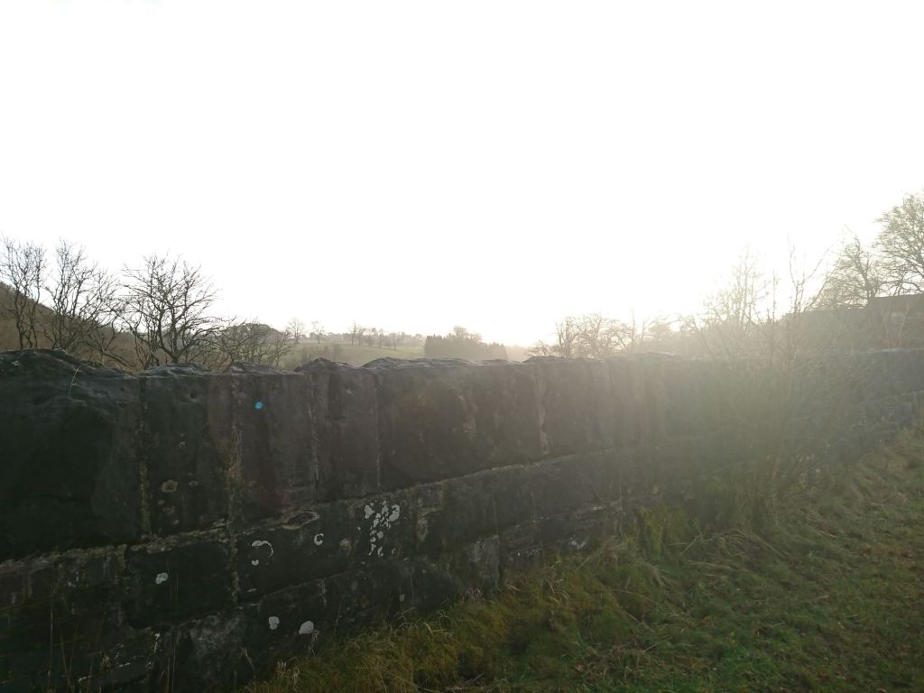 Winter sun over a low stone wall