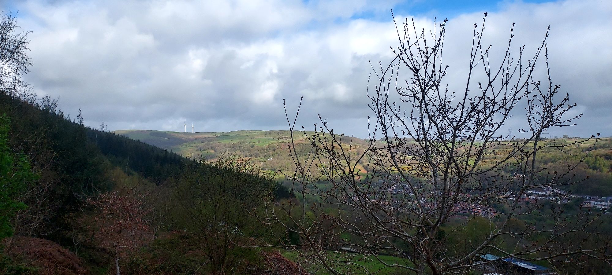Mountain landscape in sun and shade with horizon beyond